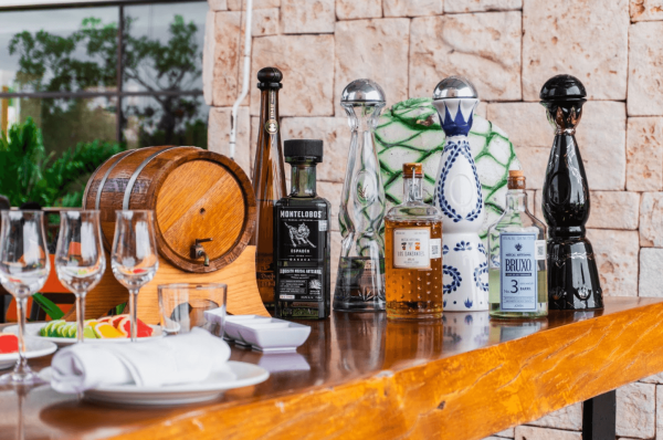 bar with mexican alcohol displayed in open-air setting